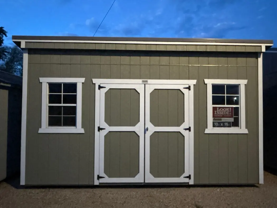 Green 10x16 Old Hickory single slope shed with white trim and double doors on the St. Boni lot